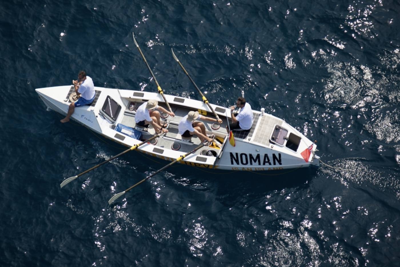 Aerial view of the ocean rowing boat NOMAN under oars on a deep blue sea