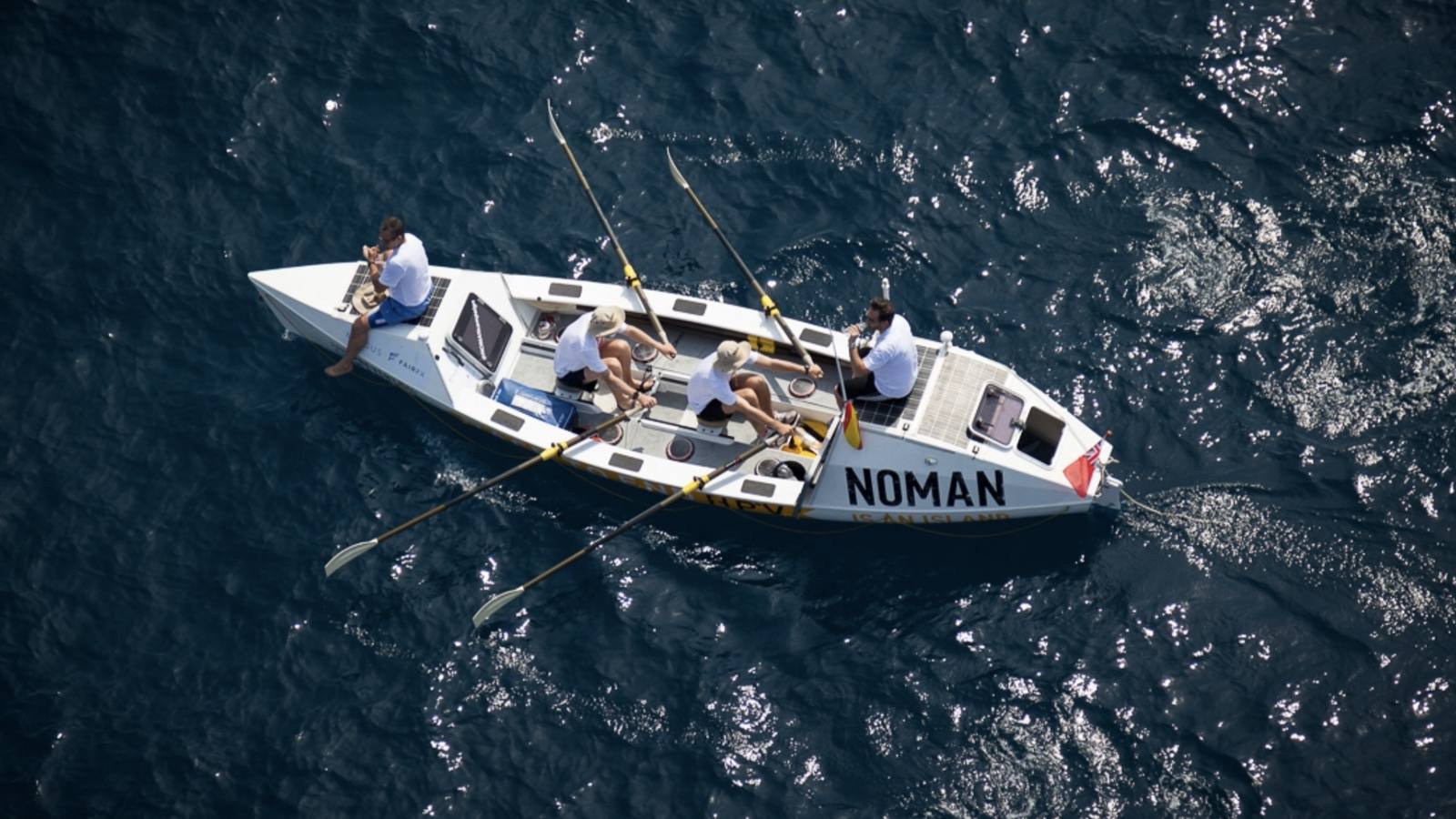 Aerial view of the ocean rowing boat NOMAN under oars on a deep blue sea